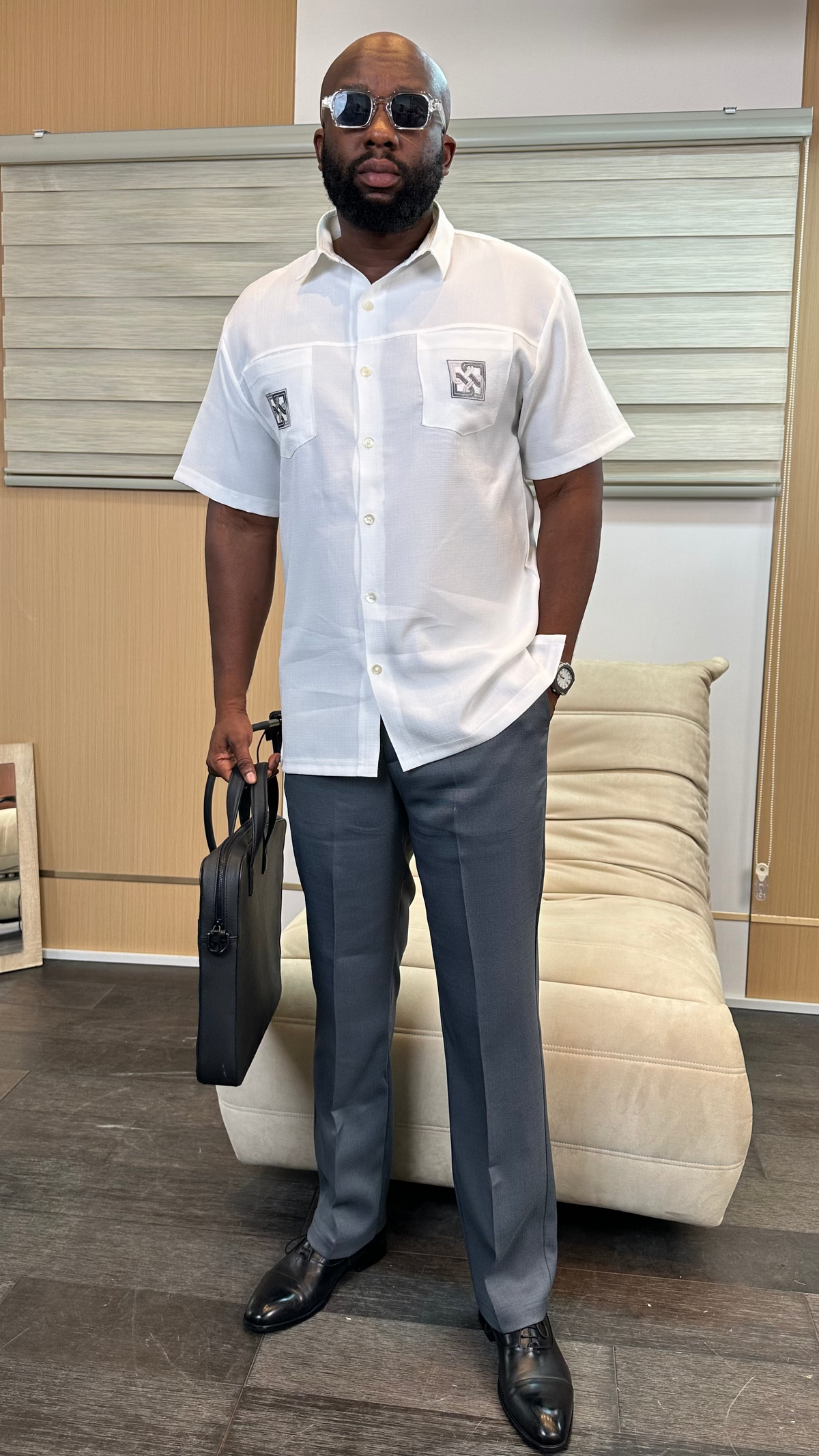 Man wearing a white short-sleeve executive shirt with charcoal tailored trousers, styled for business and formal occasions by Perfect Mann.